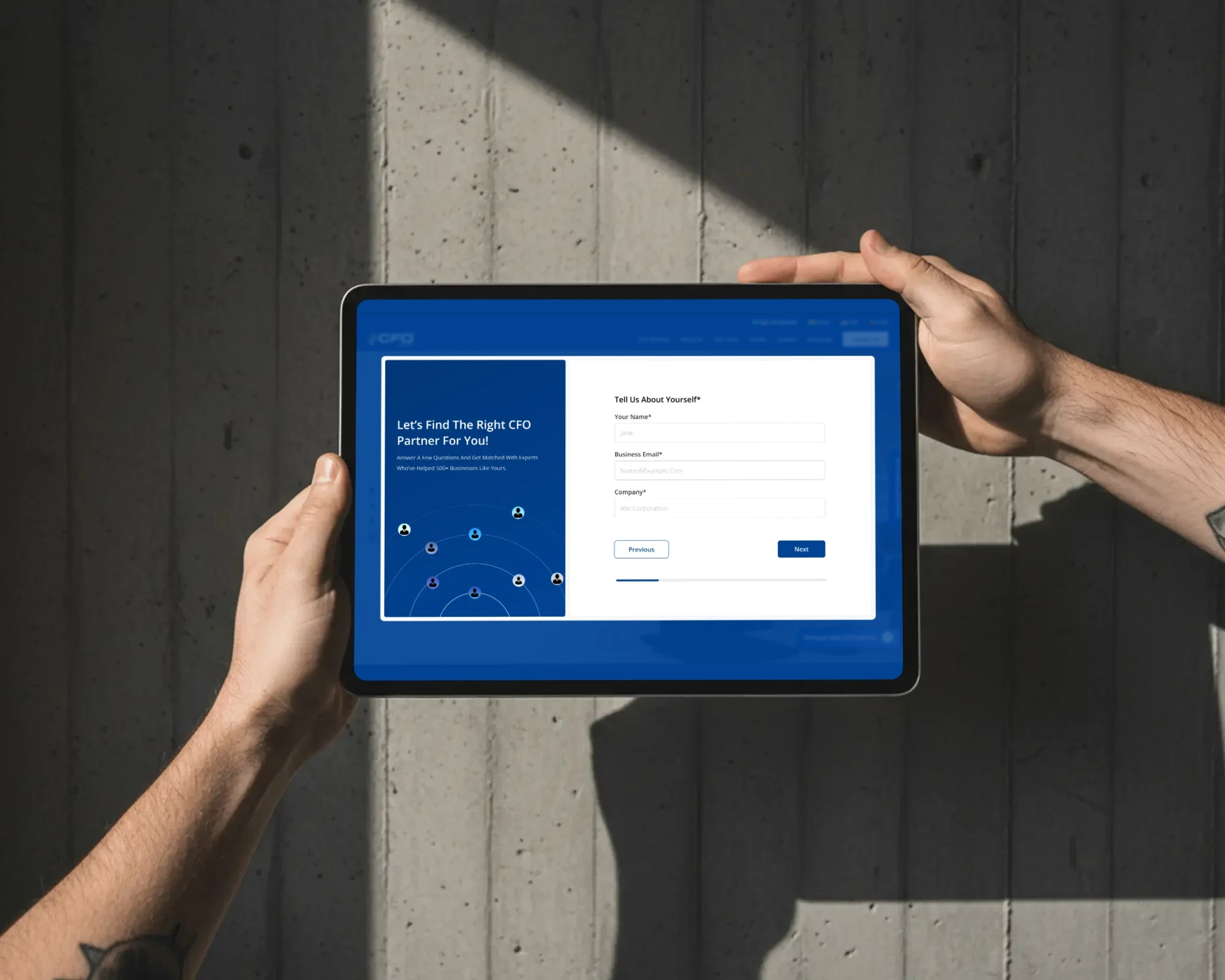 The CFO Bridge widget, 'Let's find the right CFO partner for you', on a tablet held against a concrete wall