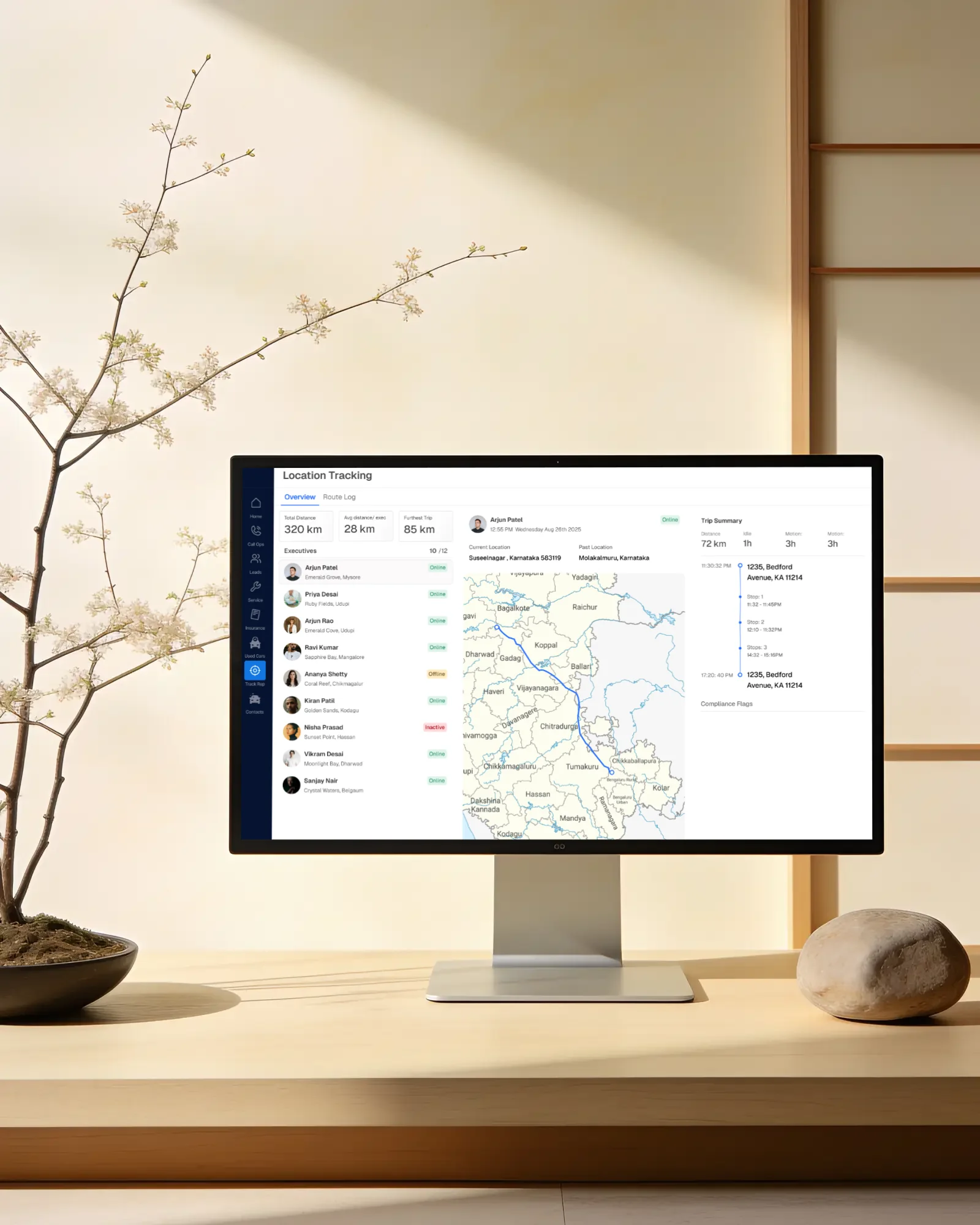 Route view on a monitor beside a blossom branch
